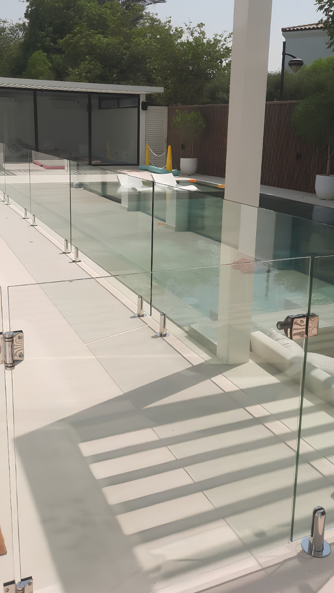 Frameless glass pool fence with a custom glass gate and polished fittings